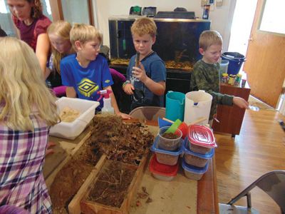 Marion Natural History Museum
The Marion Natural History Museum afterschool group had a chance to explore the soils last Wednesday. Many thanks to soil scientist Maggie Payne of the USDA's Natural Resource and Conservation Service. We learned what makes a "good" soil and why that's important to everyone, from farming to building a house. The students had fun conducting experiments with the soils and had a chance to build their own soil profiles to take home. Photo courtesy of Elizabeth Leidhold
