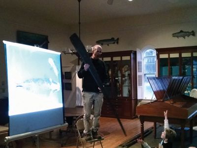 Marion Natural History Museum
Dr. Michael Moore of Woods Hole Oceanographic Institute, using the museum's harpoon and baleen, introduced the Marion Natural History Museum's after-school group to a little of Marion's whaling history. Students could ask questions and theorize why Sippican Harbor had the first recorded visit from a humpback whale this fall. We wish to thank Dr. Moore for the great program. Photo courtesy Elizabeth Leidhold
