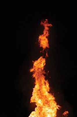 Marion Town Party 
The town collected hundreds of wood pallets and stacked them sky high in the ball field beside the Town House in anticipation of the annual Marion Town Party on Saturday, August 27. The theme of this year’s party, “Out of This World,” was appropriately represented in the playful banner hung on the stack of firewood and eventually burned along with it in an enormous bonfire. Photo by Jean Perry
