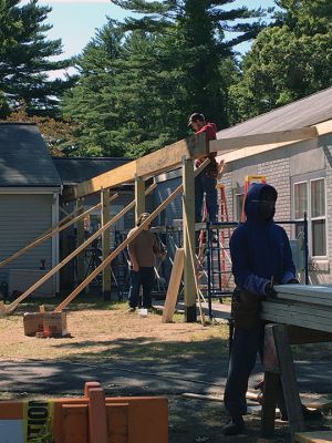 Marion's Cushing Community Center
Junior and senior-year carpentry students from Upper Cape Regional Technical School are building a permanent canopy over the entrance walkway at Marion's Cushing Community Center, formerly the Benjamin Cushing VFW. With the help of the students, the town has been able to fund the materials needed without the associated labor. Previously, Marion residents benefited from the skills of students from UCT when they reconstructed Fire Station 2 located on Point Road. Photos by Marilou Newell
