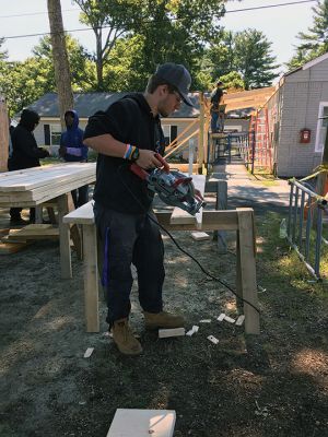 Marion's Cushing Community Center
Junior and senior-year carpentry students from Upper Cape Regional Technical School are building a permanent canopy over the entrance walkway at Marion's Cushing Community Center, formerly the Benjamin Cushing VFW. With the help of the students, the town has been able to fund the materials needed without the associated labor. Previously, Marion residents benefited from the skills of students from UCT when they reconstructed Fire Station 2 located on Point Road. Photos by Marilou Newell
