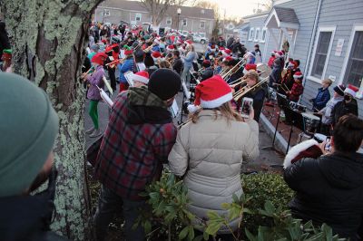 Marion Village Stroll
Cars lined several Marion streets as residents gathered for the town’s Christmas Stroll on December 12. Front Street and connecting village roads were partially closed for the event, as families enjoyed refreshments provided by area merchants at their doorsteps and along the roads. Clydesdale horses escorted Santa Claus and passengers, while the Sippican Elementary School Band played, Tabor Academy student singer Wesley Lai of Hong Kong sang, and a bike rider juggled bowling pins. Photos by Mick Colageo
