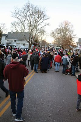 Marion Village Stroll
Cars lined several Marion streets as residents gathered for the town’s Christmas Stroll on December 12. Front Street and connecting village roads were partially closed for the event, as families enjoyed refreshments provided by area merchants at their doorsteps and along the roads. Clydesdale horses escorted Santa Claus and passengers, while the Sippican Elementary School Band played, Tabor Academy student singer Wesley Lai of Hong Kong sang, and a bike rider juggled bowling pins. Photos by Mick Colageo
