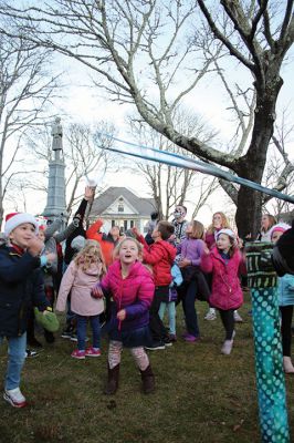 Marion Village Stroll
Cars lined several Marion streets as residents gathered for the town’s Christmas Stroll on December 12. Front Street and connecting village roads were partially closed for the event, as families enjoyed refreshments provided by area merchants at their doorsteps and along the roads. Clydesdale horses escorted Santa Claus and passengers, while the Sippican Elementary School Band played, Tabor Academy student singer Wesley Lai of Hong Kong sang, and a bike rider juggled bowling pins. Photos by Mick Colageo
