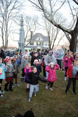 Marion Christmas Stroll 
Cars lined several Marion streets as residents gathered for the town’s Christmas Stroll on December 12. Front Street and connecting village roads were partially closed for the event, as families enjoyed refreshments provided by area merchants at their doorsteps and along the roads. Clydesdale horses escorted Santa Claus and passengers, while the Sippican Elementary School Band played, Tabor Academy student singer Wesley Lai of Hong Kong sang, and a bike rider juggled bowling pins. Photos by Mick Colageo
