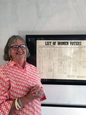 Mattapoisett Museum
Carol Clifford stands beside the 1920 women voter registration log now on display at the Mattapoisett Museum. Photo by Marilou Newell
