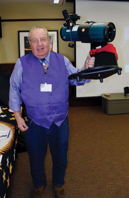 Telescope Program
John Root of the Aldrich Adopt-a-Library Program holds up the 14-pound Orion telescope. Photo by Deina Zartman
