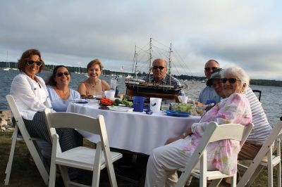 An Affair to Remember 
The Great Community Picnic on August 3 brought 345 residents out to the Munro Preserve in Mattapoisett to enjoy a late afternoon gathering hosted by the Mattapoisett Land Trust and the Historical Society. Along with great food and great wine, guests also arranged some great table centerpieces for their tables. Photos by Jean Perry
