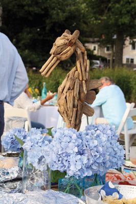 An Affair to Remember 
The Great Community Picnic on August 3 brought 345 residents out to the Munro Preserve in Mattapoisett to enjoy a late afternoon gathering hosted by the Mattapoisett Land Trust and the Historical Society. Along with great food and great wine, guests also arranged some great table centerpieces for their tables. Photos by Jean Perry
