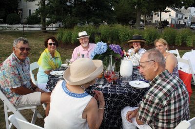 An Affair to Remember 
The Great Community Picnic on August 3 brought 345 residents out to the Munro Preserve in Mattapoisett to enjoy a late afternoon gathering hosted by the Mattapoisett Land Trust and the Historical Society. Along with great food and great wine, guests also arranged some great table centerpieces for their tables. Photos by Jean Perry
