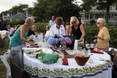 An Affair to Remember 
The Great Community Picnic on August 3 brought 345 residents out to the Munro Preserve in Mattapoisett to enjoy a late afternoon gathering hosted by the Mattapoisett Land Trust and the Historical Society. Along with great food and great wine, guests also arranged some great table centerpieces for their tables. Photos by Jean Perry
