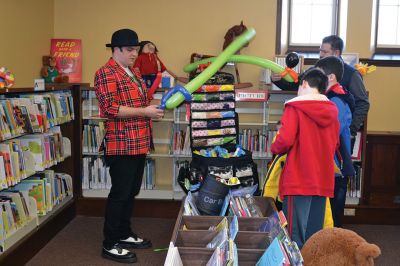 Take Your Child to the Library Day
“Take Your Child to the Library Day” is the day when libraries get to shine. At the Mattapoisett Library, kids lined up for an original work of balloon art by Chip Rascal while they also explored the various non-book offerings in the children’s section. Photos by Jean Perry
