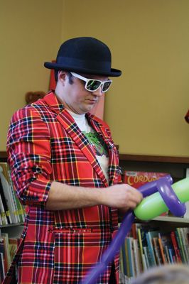 Take Your Child to the Library Day
“Take Your Child to the Library Day” is the day when libraries get to shine. At the Mattapoisett Library, kids lined up for an original work of balloon art by Chip Rascal while they also explored the various non-book offerings in the children’s section. Photos by Jean Perry
