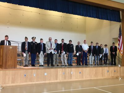Mattapoisett Memorial Day
Mattapoisett Board of Selectmen along with members of the American Legion Florence Eastman Post 280, Rep. William Straus, and special guest Col. Chris Kidd attended the Memorial Day observances at Center School on May 28. The Old Hammondtown School concert band under the direction of Cara Kinney played patriotic tunes to a full house, and afterwards the Memorial Day parade headed to the Civil War monument at the library. Photos by Marilou Newell
