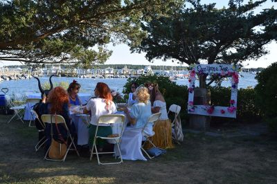 The Great Community Picnic 
Mattapoisett Museum and the Mattapoisett Land Trust held The Great Community Picnic on Thursday, August 7 at Munro Preserve on the water. Tickets were sold out and the venue was filled up. Oysters were served alongside beer and whatever food the over 20 different tables decided to bring. As with previous years, the table with the best theme won the night, that being Table 5 with their Disney theme. Photo by Sam Bishop
