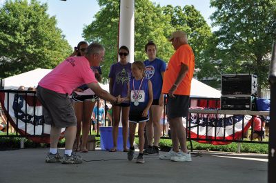 Race to the Finish 
July 4th morning in Mattapoisett means its time for the annual Mattapoisett July 4th Road Race, a five-miler that starts and finishes at Shipyard Park. The proceeds fund scholarships to ORR graduates. Photos by Sarah French Storer
