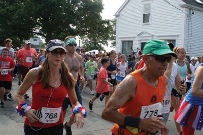 48th Annual Mattapoisett Road Race 
The 48th Annual Mattapoisett Road Race once again brought out young and old alike. Overcast skies were welcomed but the July 4th heat was tough for the runners and the cheering crowds who begged for shade. The field of runners was well over 1,000 and coming in first was Joe Farrand at 26:59. Shortly after, the first female to finish was Kim Bolick at 29:54. Before the starting gun sounded there was a moment of silence in honor of Maurice “Mudgie” Tavares who established the Mattapoisett Track Club, and the 
