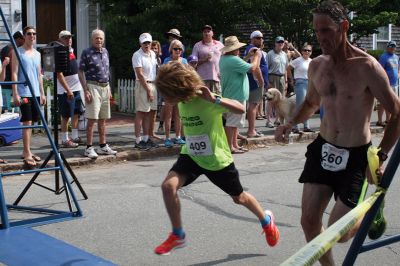 48th Annual Mattapoisett Road Race 
The 48th Annual Mattapoisett Road Race once again brought out young and old alike. Overcast skies were welcomed but the July 4th heat was tough for the runners and the cheering crowds who begged for shade. The field of runners was well over 1,000 and coming in first was Joe Farrand at 26:59. Shortly after, the first female to finish was Kim Bolick at 29:54. Before the starting gun sounded there was a moment of silence in honor of Maurice “Mudgie” Tavares who established the Mattapoisett Track Club, and the 
