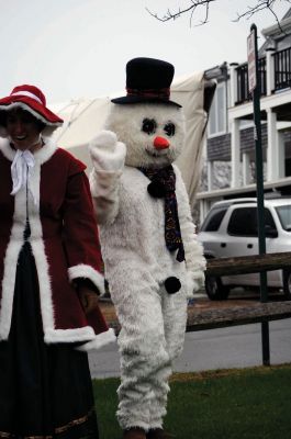 Santa Arrives
Mattapoisett held its annual holiday celebration and tree lighting on Saturday, December 5, 2009 at Shipyard Park. The rain couldn't dampen holiday spirits as visitors enjoyed delicious food and listened to Christmas music performed by the Showstoppers. Children made their own ornaments and hung them on the Christmas tree. They also danced with Rudolph and Frosty and shared their Christmas wishes with Santa Claus. Photo by Felix Perez.
