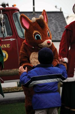 Santa Arrives
Mattapoisett held its annual holiday celebration and tree lighting on Saturday, December 5, 2009 at Shipyard Park. The rain couldn't dampen holiday spirits as visitors enjoyed delicious food and listened to Christmas music performed by the Showstoppers. Children made their own ornaments and hung them on the Christmas tree. They also danced with Rudolph and Frosty and shared their Christmas wishes with Santa Claus. Photo by Felix Perez.
