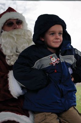 Santa Arrives
Mattapoisett held its annual holiday celebration and tree lighting on Saturday, December 5, 2009 at Shipyard Park. The rain couldn't dampen holiday spirits as visitors enjoyed delicious food and listened to Christmas music performed by the Showstoppers. Children made their own ornaments and hung them on the Christmas tree. They also danced with Rudolph and Frosty and shared their Christmas wishes with Santa Claus. Photo by Felix Perez.
