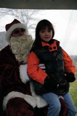 Santa Arrives
Mattapoisett held its annual holiday celebration and tree lighting on Saturday, December 5, 2009 at Shipyard Park. The rain couldn't dampen holiday spirits as visitors enjoyed delicious food and listened to Christmas music performed by the Showstoppers. Children made their own ornaments and hung them on the Christmas tree. They also danced with Rudolph and Frosty and shared their Christmas wishes with Santa Claus. Photo by Felix Perez.
