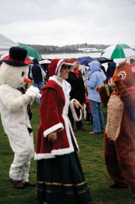 Santa Arrives
Mattapoisett held its annual holiday celebration and tree lighting on Saturday, December 5, 2009 at Shipyard Park. The rain couldn't dampen holiday spirits as visitors enjoyed delicious food and listened to Christmas music performed by the Showstoppers. Children made their own ornaments and hung them on the Christmas tree. They also danced with Rudolph and Frosty and shared their Christmas wishes with Santa Claus. Photo by Felix Perez.
