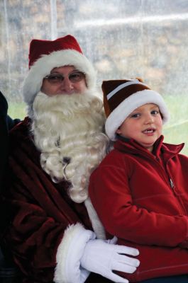 Santa Arrives
Mattapoisett held its annual holiday celebration and tree lighting on Saturday, December 5, 2009 at Shipyard Park. The rain couldn't dampen holiday spirits as visitors enjoyed delicious food and listened to Christmas music performed by the Showstoppers. Children made their own ornaments and hung them on the Christmas tree. They also danced with Rudolph and Frosty and shared their Christmas wishes with Santa Claus. Photo by Felix Perez.
