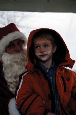 Santa Arrives
Mattapoisett held its annual holiday celebration and tree lighting on Saturday, December 5, 2009 at Shipyard Park. The rain couldn't dampen holiday spirits as visitors enjoyed delicious food and listened to Christmas music performed by the Showstoppers. Children made their own ornaments and hung them on the Christmas tree. They also danced with Rudolph and Frosty and shared their Christmas wishes with Santa Claus. Photo by Felix Perez.
