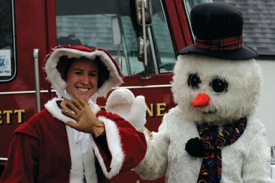 Santa Arrives
Mattapoisett held its annual holiday celebration and tree lighting on Saturday, December 5, 2009 at Shipyard Park. The rain couldn't dampen holiday spirits as visitors enjoyed delicious food and listened to Christmas music performed by the Showstoppers. Children made their own ornaments and hung them on the Christmas tree. They also danced with Rudolph and Frosty and shared their Christmas wishes with Santa Claus. Photo by Felix Perez.
