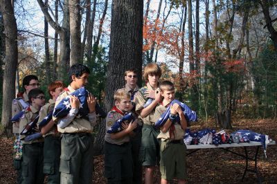 Veterans Day Ceremony in Mattapoiset
On November 11 following the Veterans Day Ceremony at Old Hammondtown School in Mattapoisett, members of Boy Scout Troop 53 performed a flag decommissioning ceremony at the Mattapoisett Land Trust’s Dunseith Gardens. Flags had been placed in decommissioning boxes built by Drew Robert for his Eagle project. The flags were then collected from the boxes located at the police department, town hall and public library and prepared for burning and burial. 
