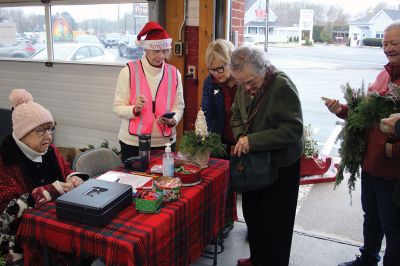 Mattapoisett Woman’s Club
Sandra Hering is decked out in Santa attire as she invites traffic to turn into Saturday morning’s sale of wreaths and other assorted Christmas decorations at the Fire Station on the corner of Route 6 and Barstow in Mattapoisett. The annual event, put on by the Mattapoisett Woman’s Club, raises money to fund a college scholarship. Photos by Mick Colageo
