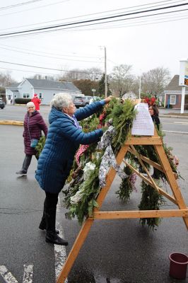 Mattapoisett Woman’s Club
Sandra Hering is decked out in Santa attire as she invites traffic to turn into Saturday morning’s sale of wreaths and other assorted Christmas decorations at the Fire Station on the corner of Route 6 and Barstow in Mattapoisett. The annual event, put on by the Mattapoisett Woman’s Club, raises money to fund a college scholarship. Photos by Mick Colageo
