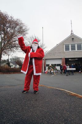 Mattapoisett Woman’s Club
Sandra Hering is decked out in Santa attire as she invites traffic to turn into Saturday morning’s sale of wreaths and other assorted Christmas decorations at the Fire Station on the corner of Route 6 and Barstow in Mattapoisett. The annual event, put on by the Mattapoisett Woman’s Club, raises money to fund a college scholarship. Photos by Mick Colageo
