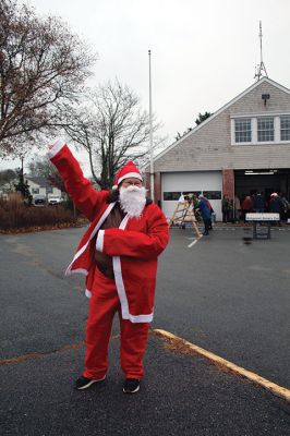 Mattapoisett Woman’s Club
Sandra Hering is decked out in Santa attire as she invites traffic to turn into Saturday morning’s sale of wreaths and other assorted Christmas decorations at the Fire Station on the corner of Route 6 and Barstow in Mattapoisett. The annual event, put on by the Mattapoisett Woman’s Club, raises money to fund a college scholarship. Photos by Mick Colageo
