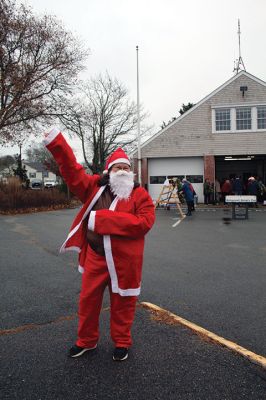 Mattapoisett Woman’s Club
Sandra Hering is decked out in Santa attire as she invites traffic to turn into Saturday morning’s sale of wreaths and other assorted Christmas decorations at the Fire Station on the corner of Route 6 and Barstow in Mattapoisett. The annual event, put on by the Mattapoisett Woman’s Club, raises money to fund a college scholarship. Photos by Mick Colageo
