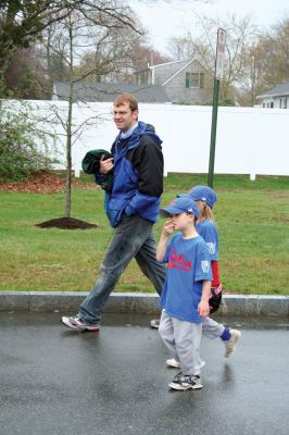 Opening Day
The Mattapoisett Youth Baseball League opened their 2009 season with a parade down Route Six on Saturday morning, May 2. Special guest and Boston Red Sox mascot Wally the Green Monster was on hand to throw out the first pitch and sign autographs for the young players. Photo by Robert Chiarito.
