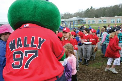 Opening Day
The Mattapoisett Youth Baseball League opened their 2009 season with a parade down Route Six on Saturday morning, May 2. Special guest and Boston Red Sox mascot Wally the Green Monster was on hand to throw out the first pitch and sign autographs for the young players. Photo by Robert Chiarito.
