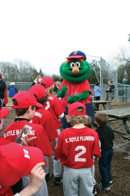 Opening Day
The Mattapoisett Youth Baseball League opened their 2009 season with a parade down Route Six on Saturday morning, May 2. Special guest and Boston Red Sox mascot Wally the Green Monster was on hand to throw out the first pitch and sign autographs for the young players. Photo by Robert Chiarito.
