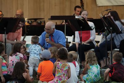 Young People’s Concert
The Marion Concert Band catered to the young ones on July 27 during its children’s-themed performance, “Young People’s Concert,” with selected songs familiar to children. Here, band conductor Tobias Monte sits onstage with the children, firing up their imaginations, and handing out instruments for the children to experiment with. Photos by Jean Perry
