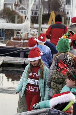 Marion Holiday Stroll
The Marion village streets were filled with holiday revelers on Sunday, December 9, for the annual Marion Holiday Stroll. Santa’s boat docked at the Marion Wharf where the faces of hundreds of children lit up at his arrival. Santa boarded a horse-drawn carriage and paraded through the streets, passing businesses offering free goodies and dodging the whereabouts of that old Grinch who didn’t seem to mind Christmas coming at all this year. Photos by Jean Perry
