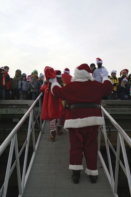 Marion Holiday Stroll
The Marion village streets were filled with holiday revelers on Sunday, December 9, for the annual Marion Holiday Stroll. Santa’s boat docked at the Marion Wharf where the faces of hundreds of children lit up at his arrival. Santa boarded a horse-drawn carriage and paraded through the streets, passing businesses offering free goodies and dodging the whereabouts of that old Grinch who didn’t seem to mind Christmas coming at all this year. Photos by Jean Perry
