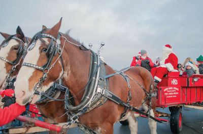 Marion Village Stroll 
The Marion Village Stroll on Sunday includes a visit from Santa who arrived by boat and then was transported by wagon to meet the children. Photo by Felix Perez
