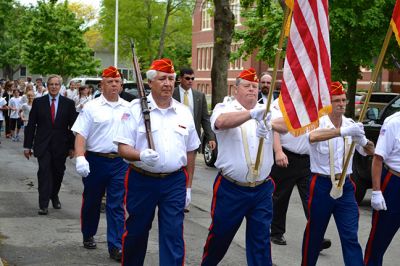 Memorial Day 2014
Scores of Mattapoisett residents gathered in front of the Mattapoisett Free Library the drizzly afternoon of May 26 to pay homage to veteran Americans who lost their lives. Onlookers filled the lawn and spilled out into the street to watch the Memorial Day ceremony with special guest speaker Navy Reserve Commander Paul J. Brawley who served more than 22 years of active duty and reserve service. After the ceremony, participants paraded through the town to the town wharf. Photo By Jean Perry
