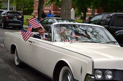 Memorial Day 2014
Scores of Mattapoisett residents gathered in front of the Mattapoisett Free Library the drizzly afternoon of May 26 to pay homage to veteran Americans who lost their lives. Onlookers filled the lawn and spilled out into the street to watch the Memorial Day ceremony with special guest speaker Navy Reserve Commander Paul J. Brawley who served more than 22 years of active duty and reserve service. After the ceremony, participants paraded through the town to the town wharf. Photo By Jean Perry
