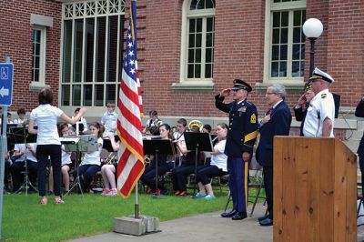 Memorial Day 2014
Scores of Mattapoisett residents gathered in front of the Mattapoisett Free Library the drizzly afternoon of May 26 to pay homage to veteran Americans who lost their lives. Onlookers filled the lawn and spilled out into the street to watch the Memorial Day ceremony with special guest speaker Navy Reserve Commander Paul J. Brawley who served more than 22 years of active duty and reserve service. After the ceremony, participants paraded through the town to the town wharf. Photo By Jean Perry
