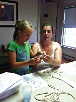 Mattapoisett Historical Society
Mattapoisett Historical Society museum curator Elizabeth Hutchison explaining how to make a type of sailor's knot at the museum's "History by Hand" event last week. Photo by Renae Reints.
