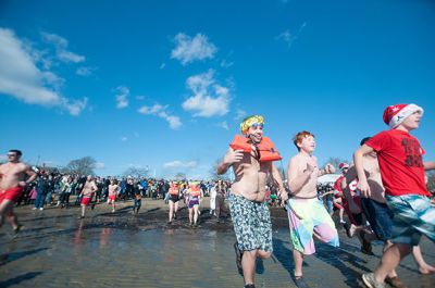 Freezin' for a Reason 2014
Participants in the 2014 Polar Plunge on January 1 were encouraged to wear costumes for the event, which raised thousands of dollars for the BAM Foundation. BAM is an organization that offers financial assistance to families battling cancer to help offset the unexpected costs of cancer treatment. Hundreds of people turned out for the event, with over a hundred participants who plunged into 34 degree waters, just a few degrees warmer than the 28 degree air temperature that morning.  Photo by Felix Perez
