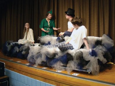 Peter Pan
Emma Jones, in green costume, rehearses a scene with fellow cast members Megan Correia, Jonah Duke (top hat) and Alec Taylor for the Old Colony Drama club's production of "Peter Pan" at the regional vocational high school's Rochester campus. There will be two performances, on Saturday night and on Sunday afternoon. Photo by Mick Colageo
