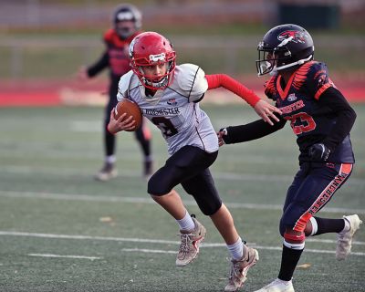 Old Rochester Youth Football 
Connor Nelson of the Old Rochester Youth Football 12-and-under team holds the snap as Giovanni Scherer kicks a field goal during the Bulldogs’ recent 30-24 victory over previously undefeated Manchester, Connecticut. Photo courtesy of Phil Mello

